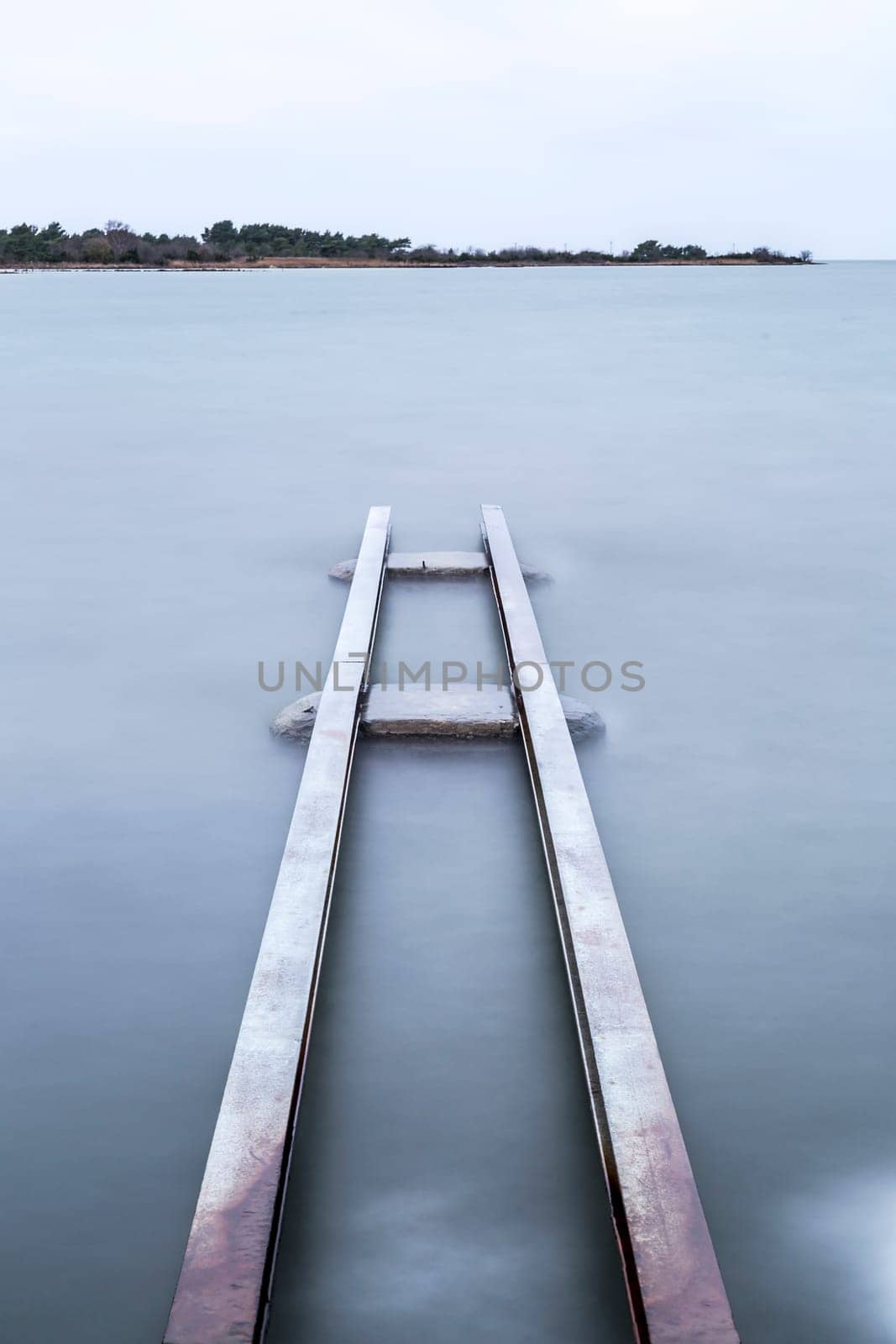 Steel Structure in Water with a cloudy sky.