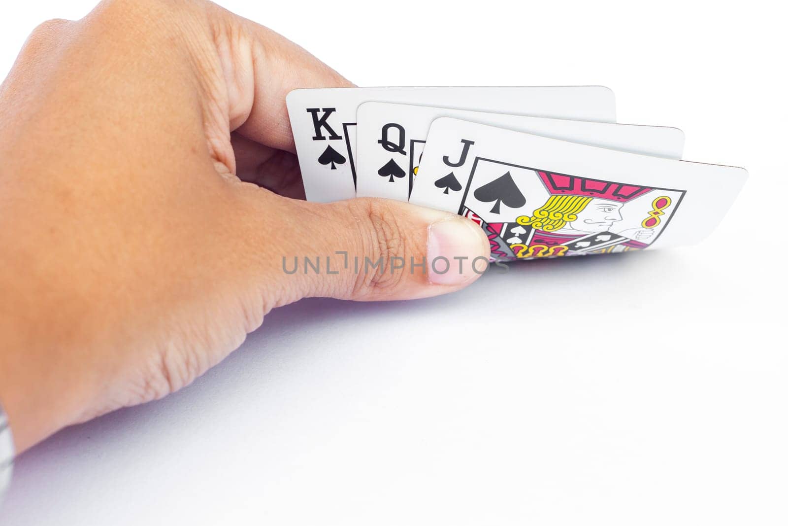 Playing cards in hand isolated on white background, stock photo