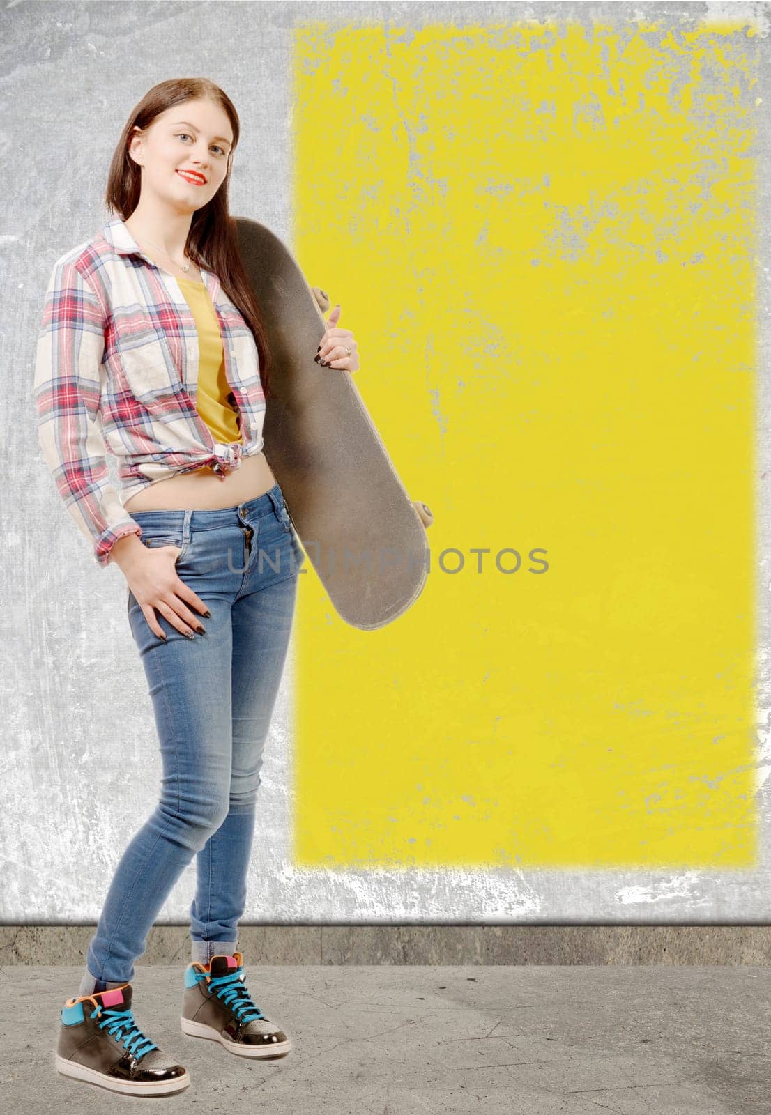 a smiling skater girl holding skateboard