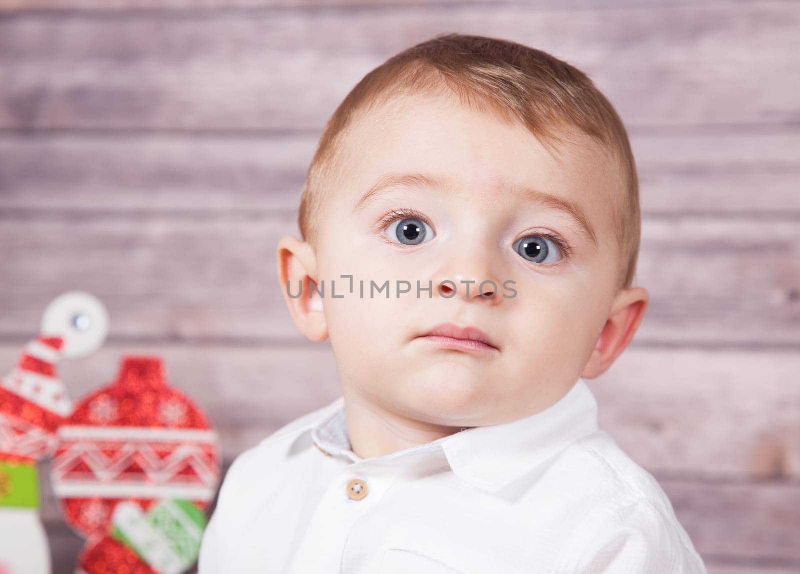 Portrait of 1 year old baby boy, Christmas theme, studio shot.
