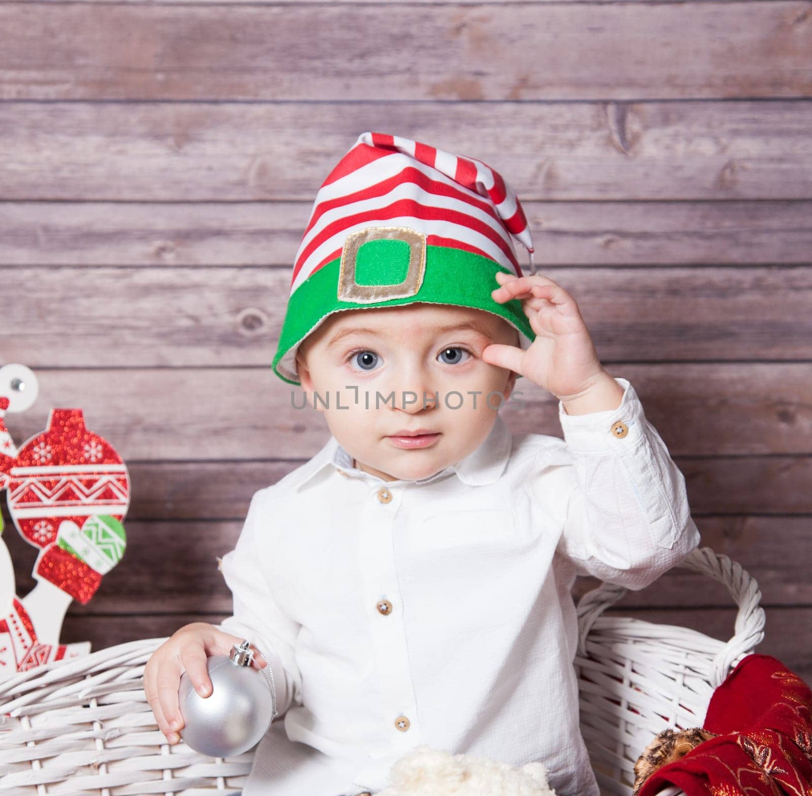 Portrait of 1 year old baby boy, Christmas theme, studio shot.