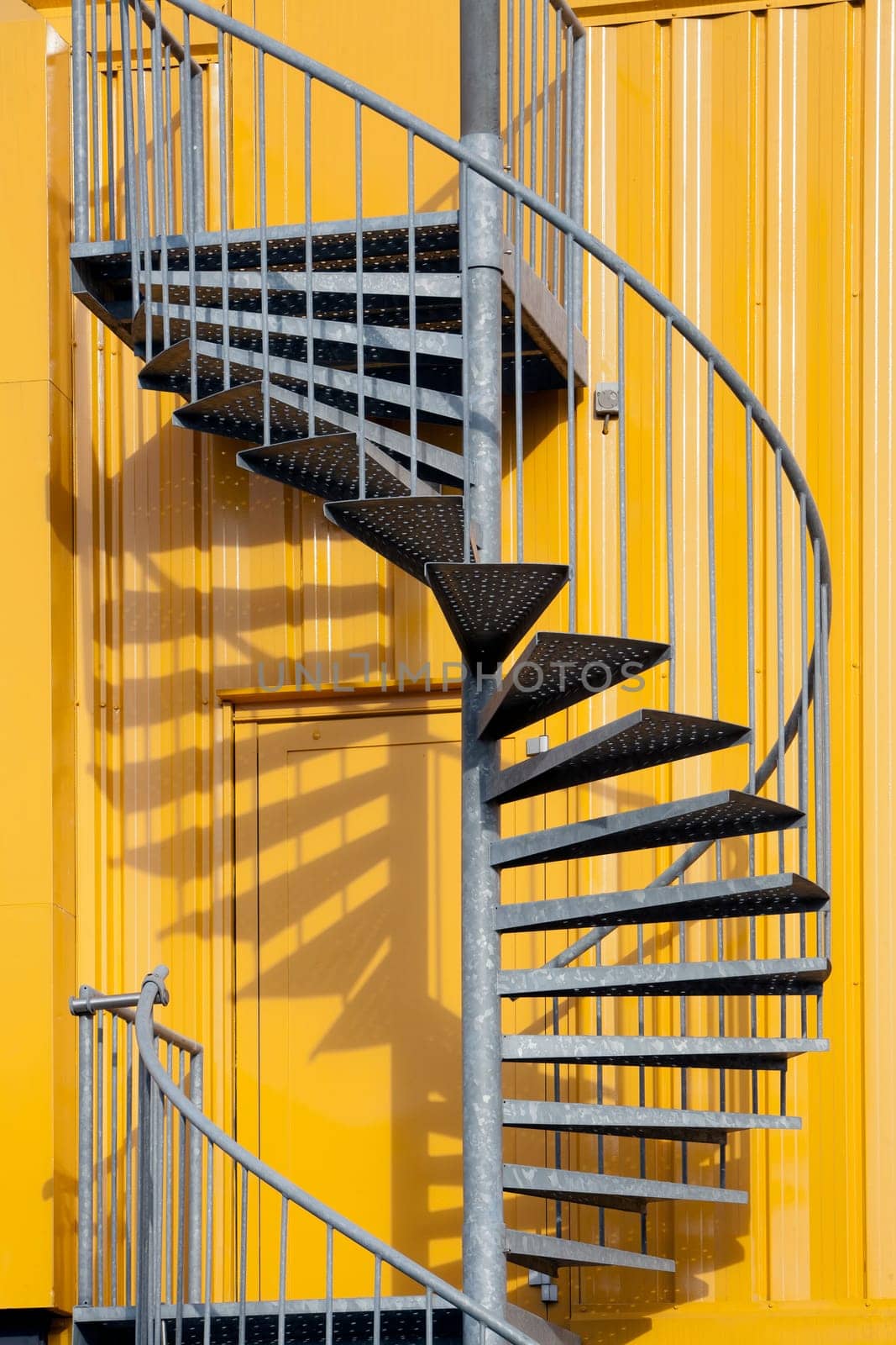 Yellow building with spiral metal staircase