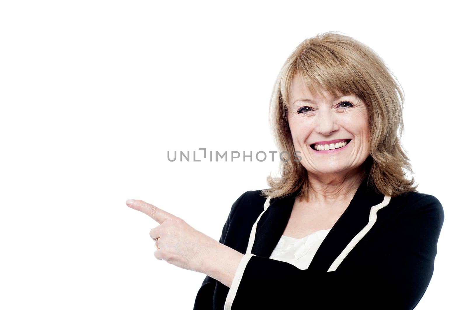 Beautiful old lady pointing towards the copy space area