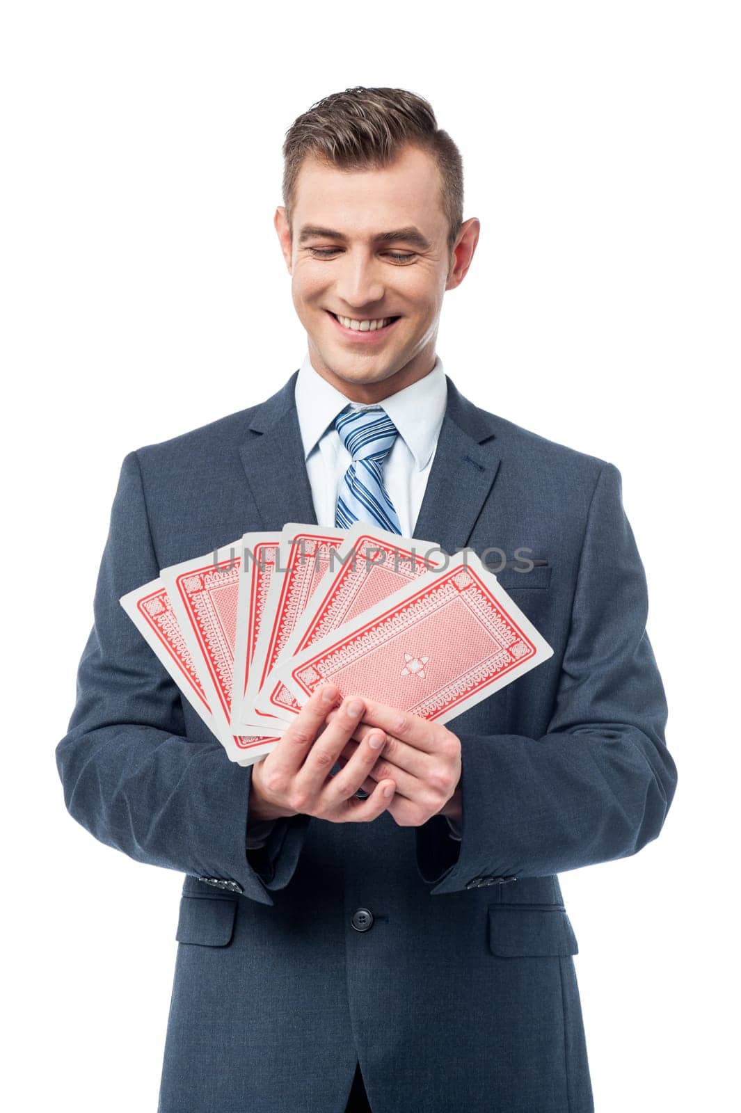 Smiling business professional holding playing cards
