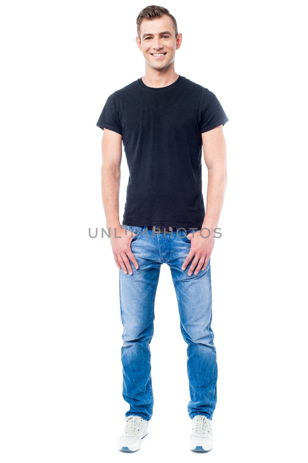 Full length image of a young guy with hands in pockets