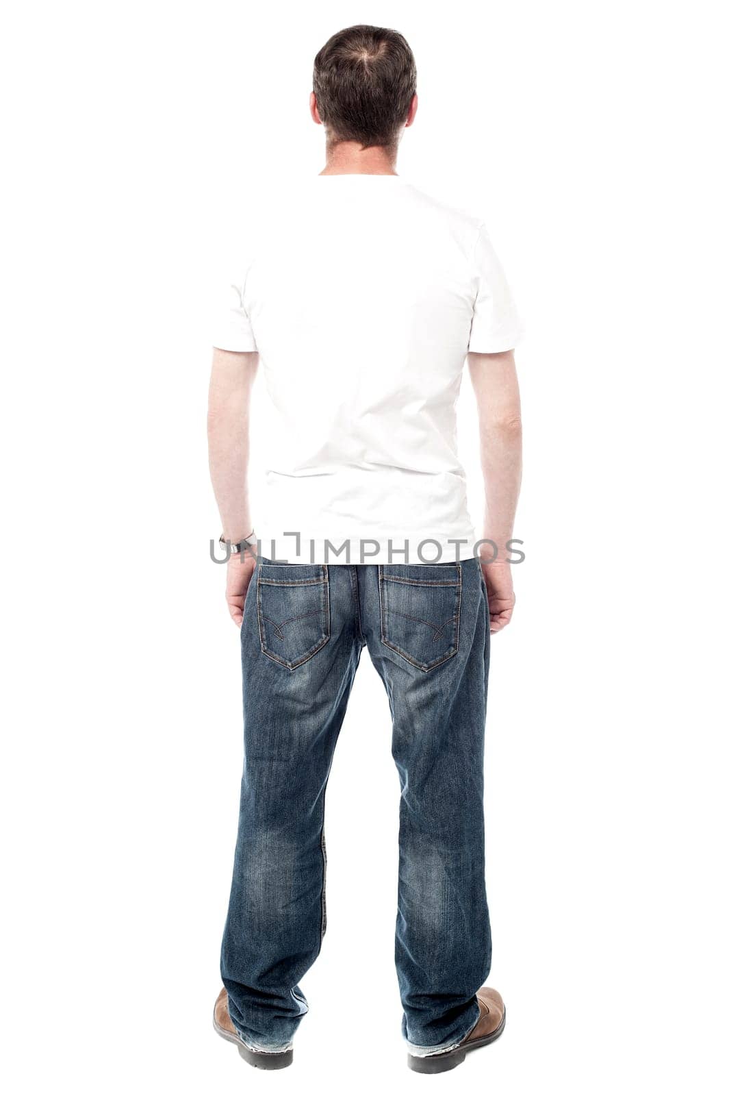 Back pose of a middle aged man facing wall