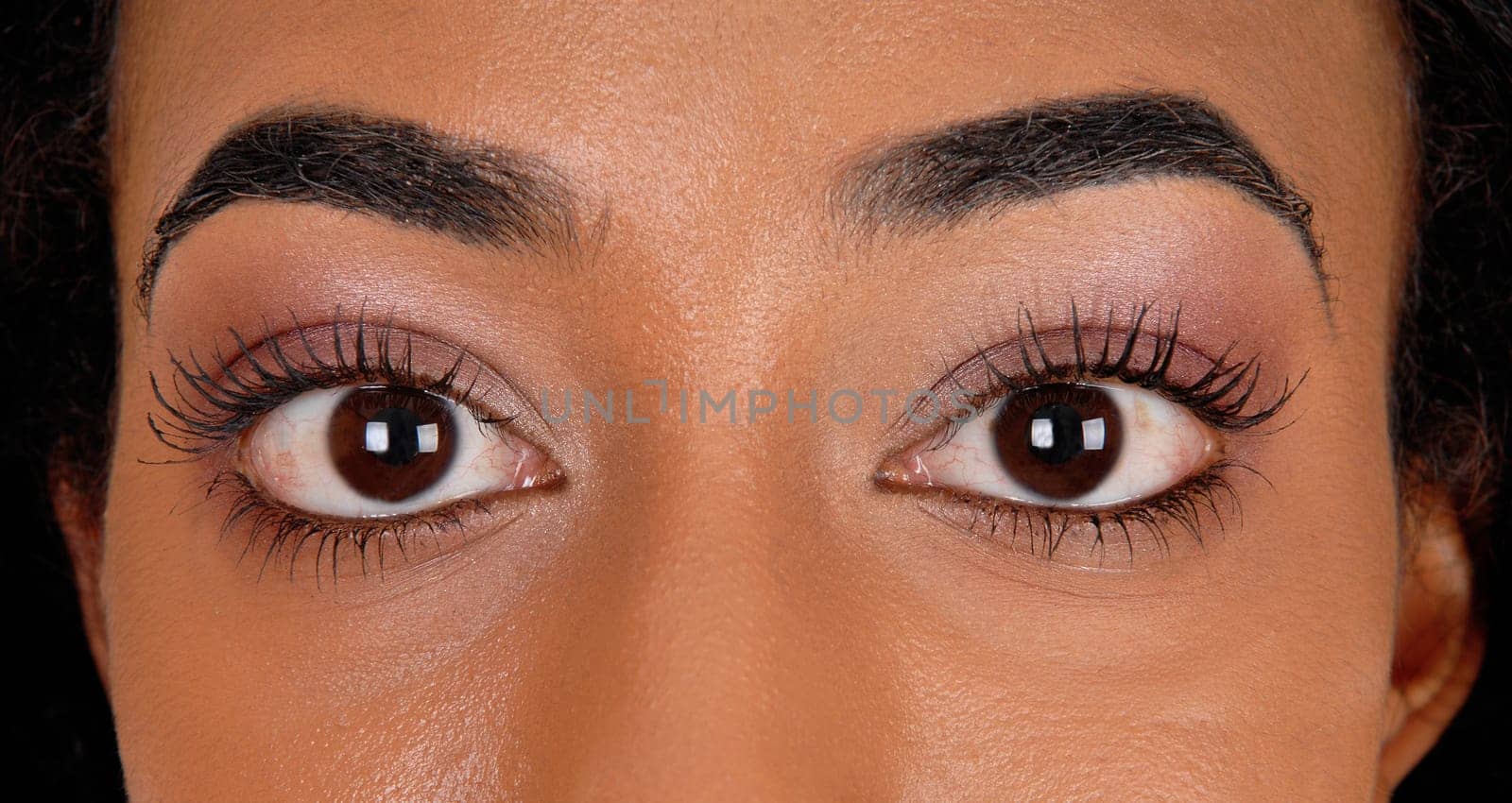 A closeup image of the big eye's of an African American woman..