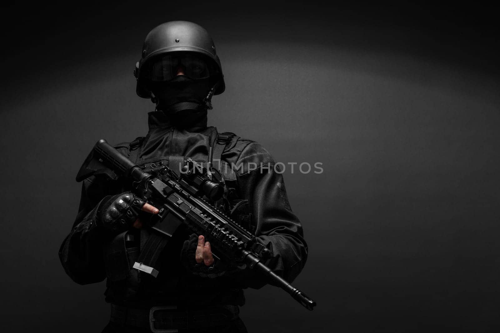 Spec ops police officer SWAT in black uniform studio