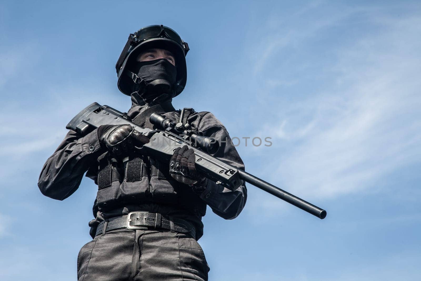 SWAT police sniper in black uniform in action