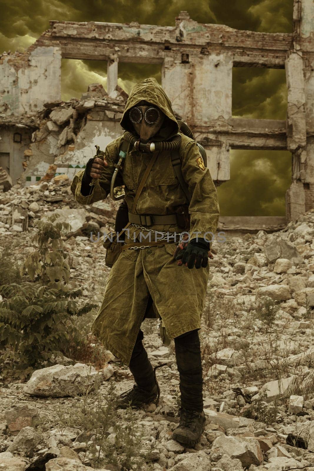 Post apocalypse. Sole survivor in tatters and gas mask on the ruins of the destroyed city