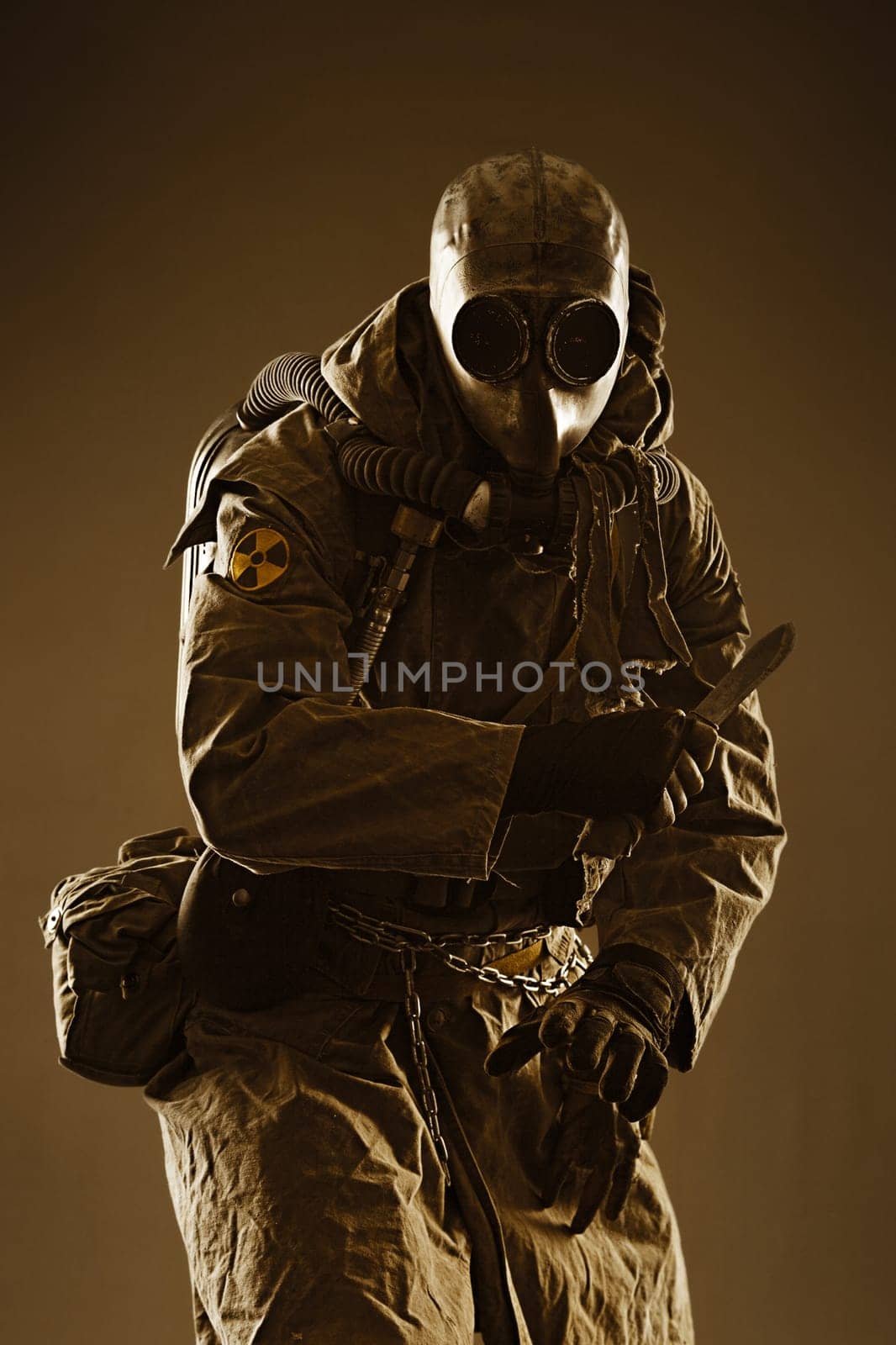Nuclear post apocalypse. Studio shot of survivor in tatters and gas mask
