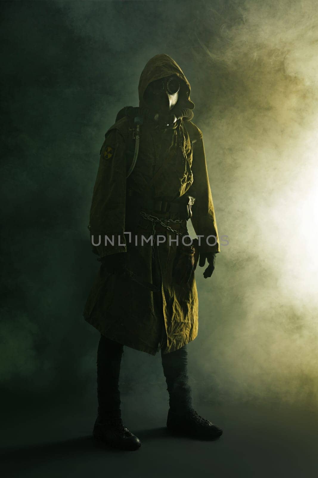 Nuclear post apocalypse. Studio shot of survivor in tatters and gas mask