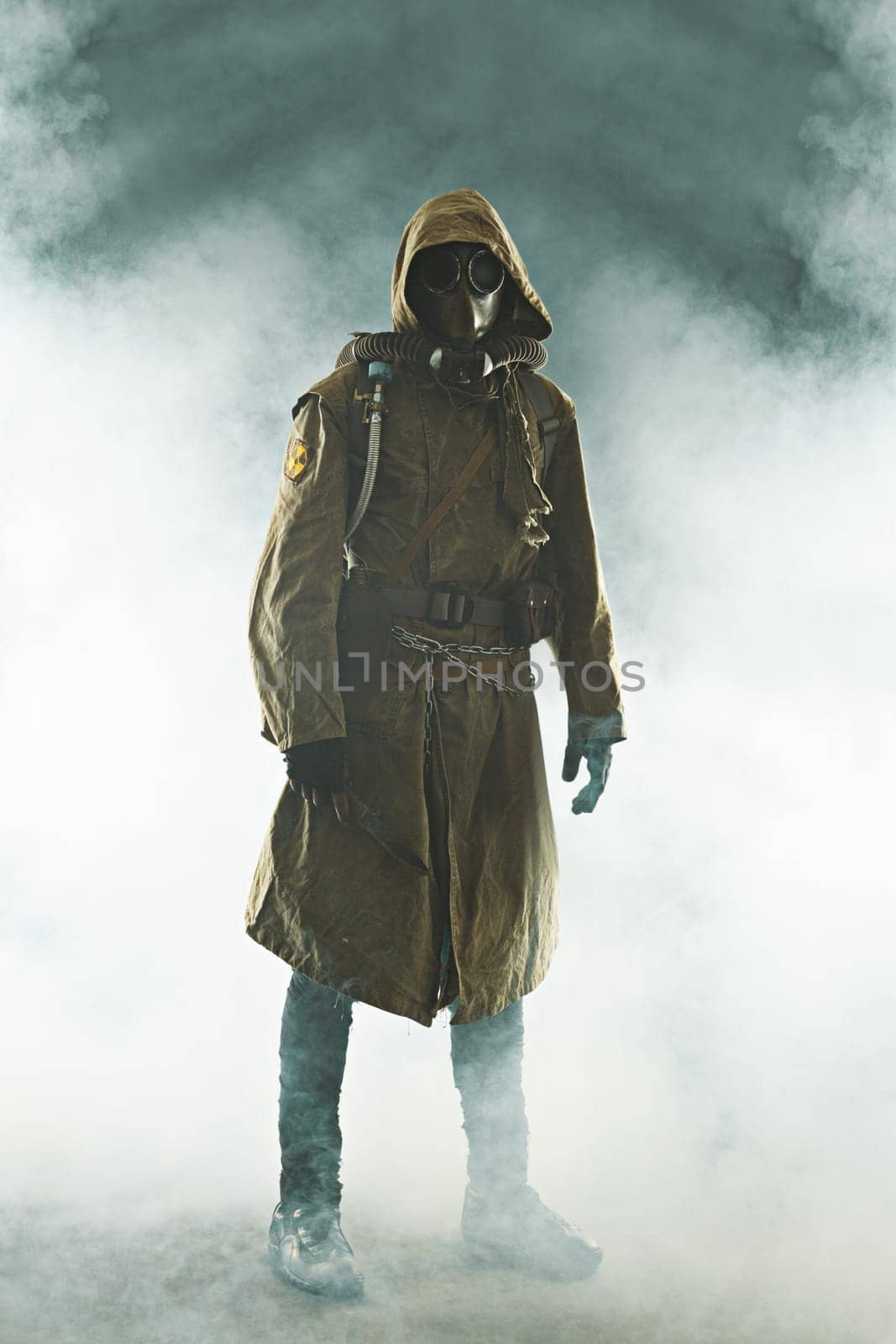 Nuclear post apocalypse. Studio shot of survivor in tatters and gas mask