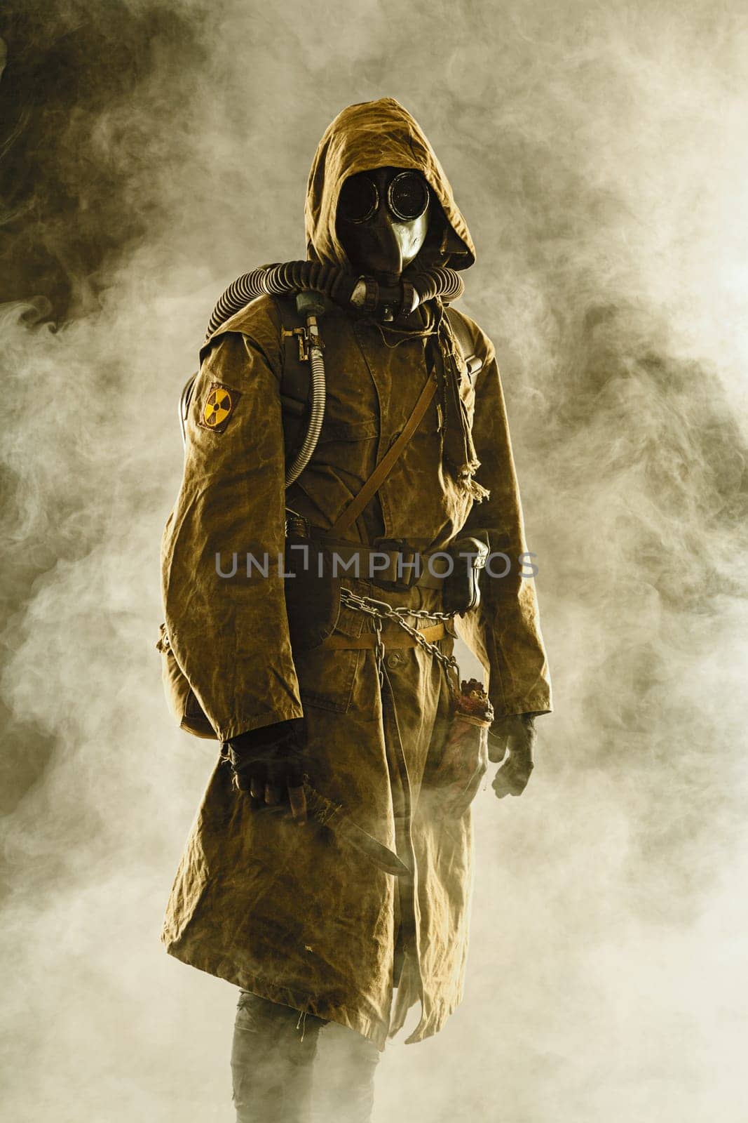 Nuclear post apocalypse. Studio shot of survivor in tatters and gas mask
