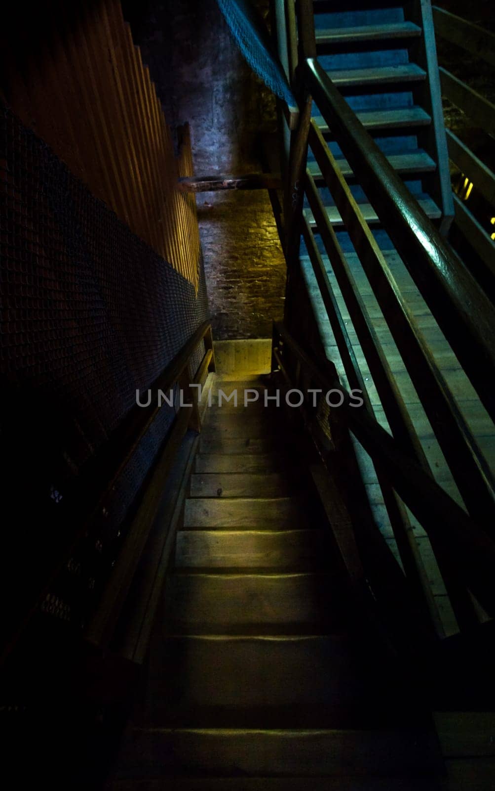 An old dangerous wooden staircase leads into the dark dungeon
