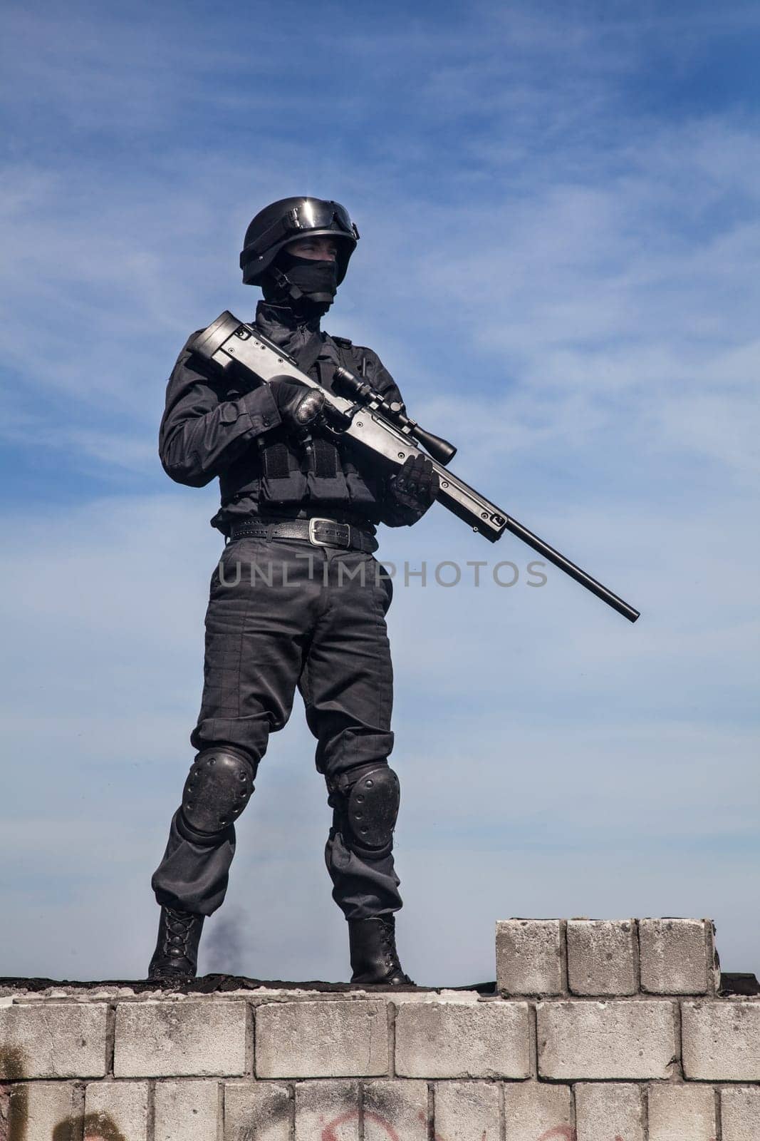 SWAT police sniper in black uniform in action
