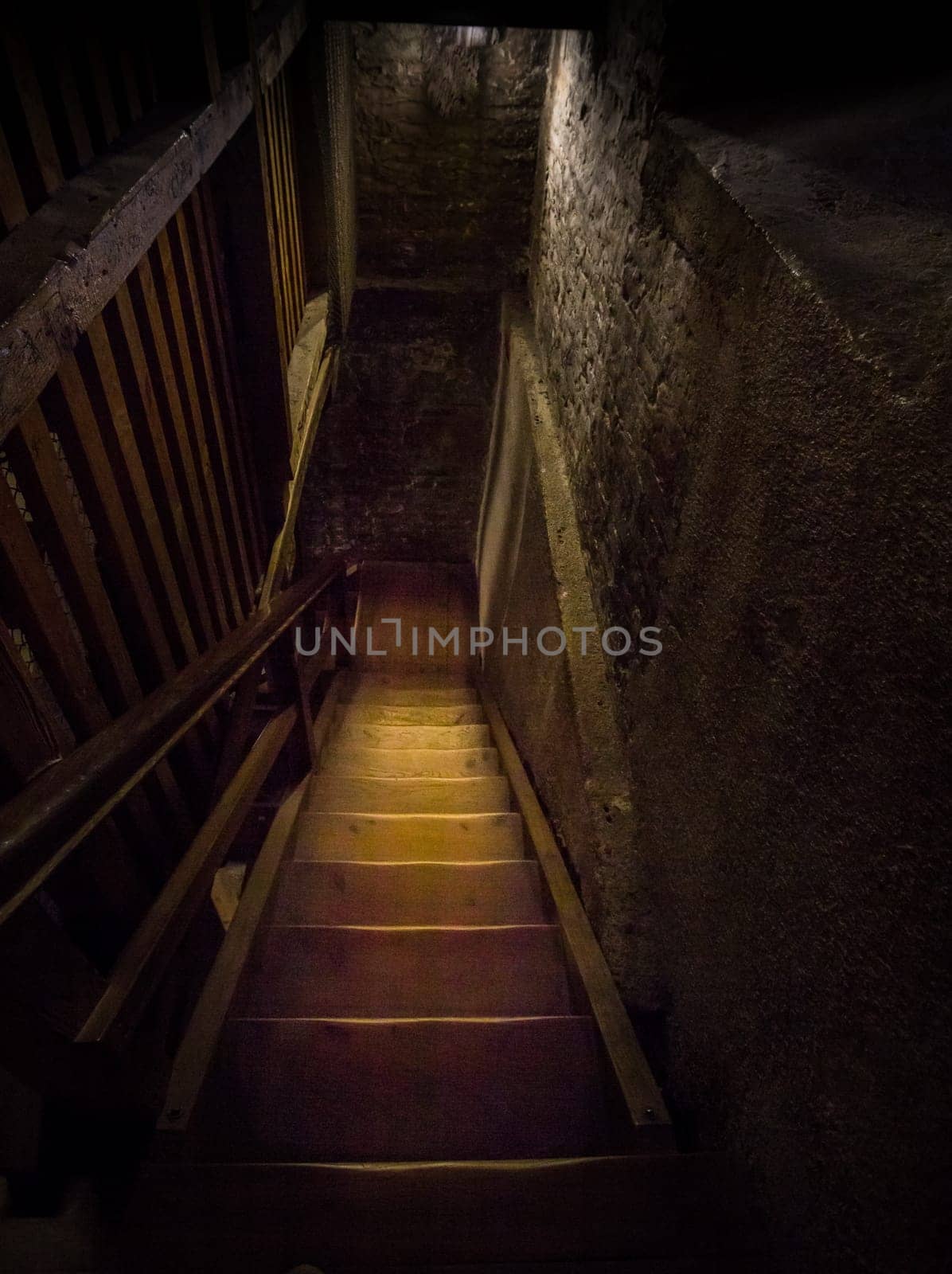 An old dangerous wooden staircase leads into the dark dungeon