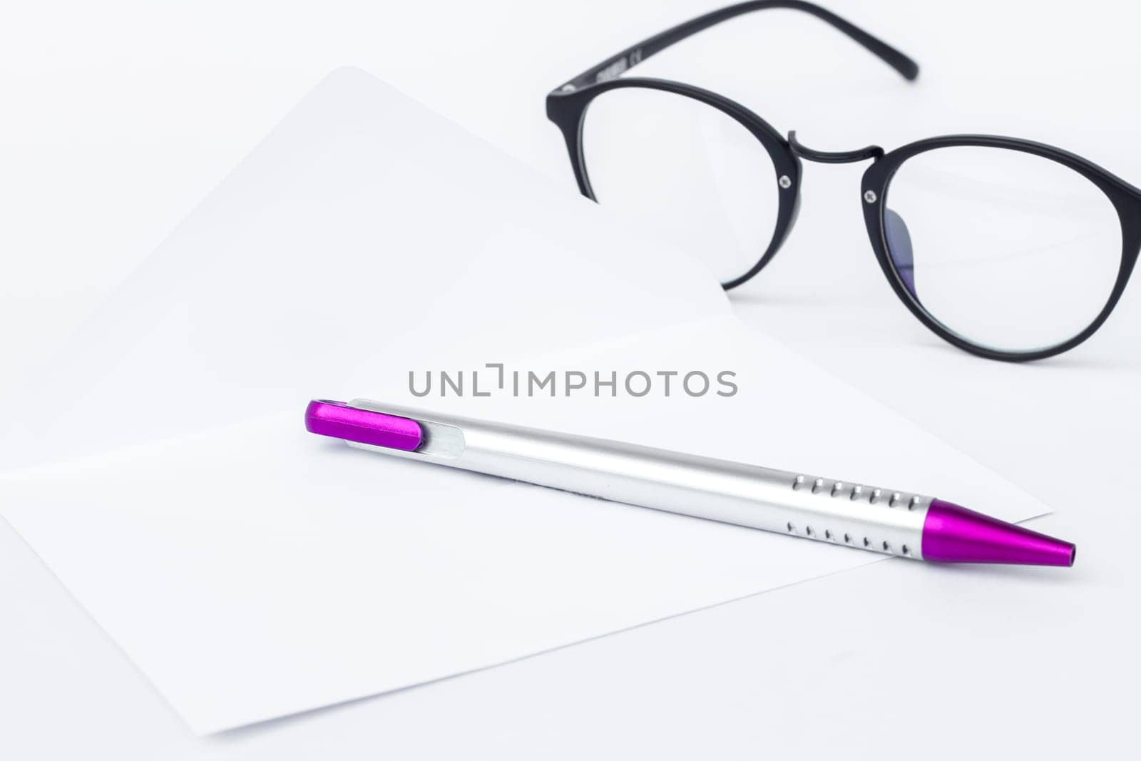 Envelope with pen isolated on white background, stock photo