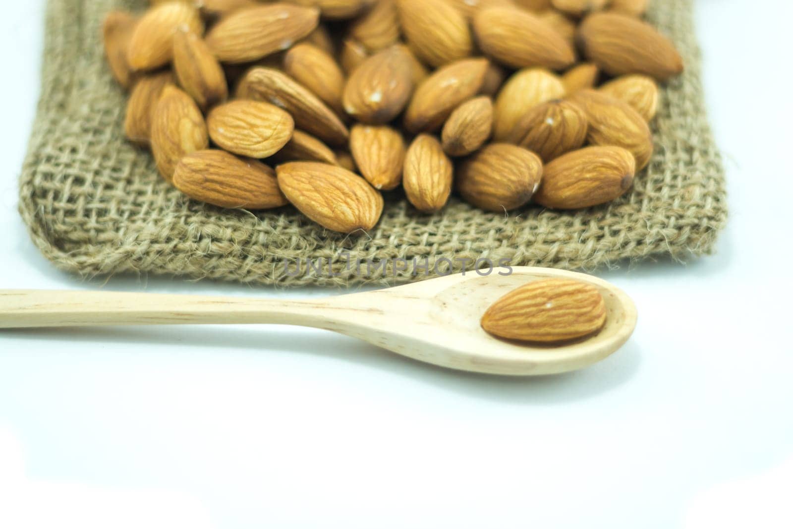 Almonds in sack isolated on white background, stock photo