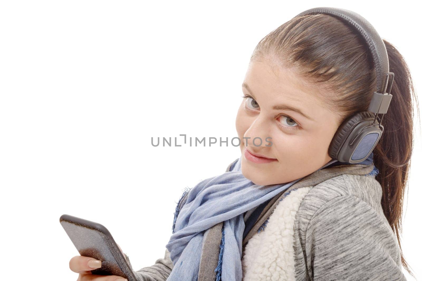 a young woman listening to music with his mobile phone and headphone