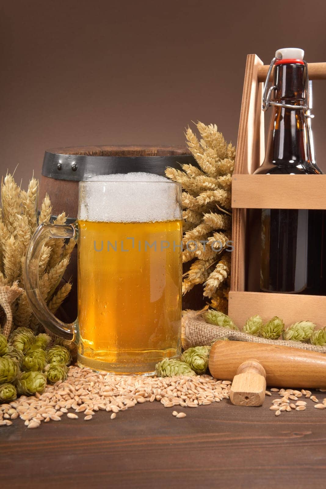 Beer carriers,beer barrels and beer glasses with wheat,barley,hops and malt