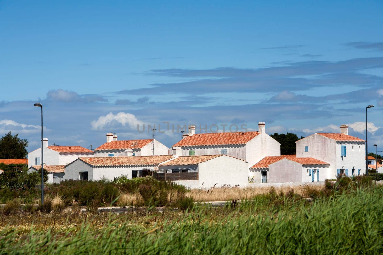 Village view on Noirmoutier island in France. Tranquil residential district with white plastered houses