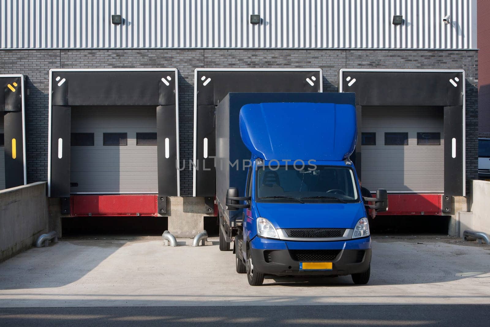 Warehouse loading dock and a blue truck