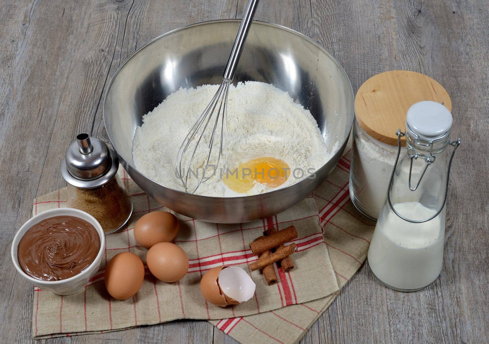 preparing pancakes with sugarand chocolate on a wooden table