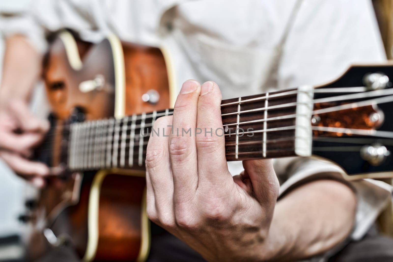 close-up on the fingers of the guitarist
