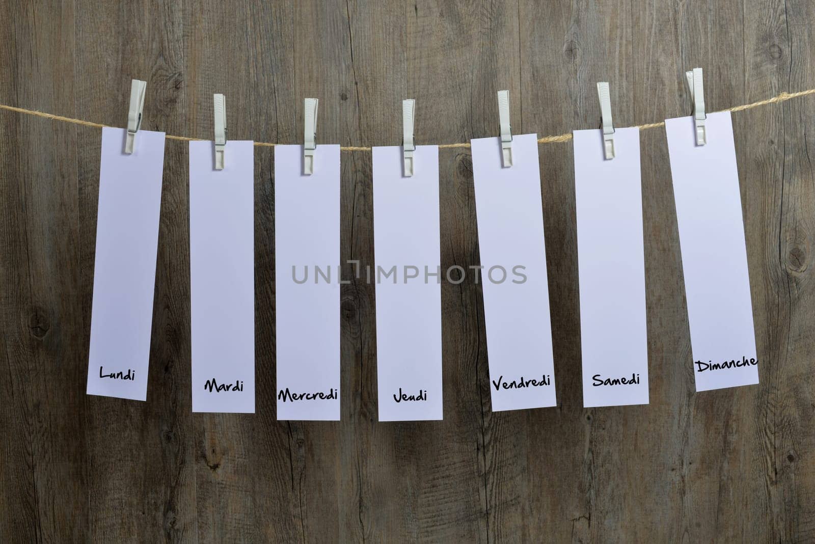 seven sheets of paper hanging on a clothesline