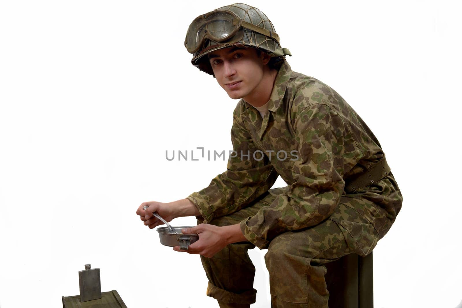 young American soldier in camouflage uniform, takes his meals