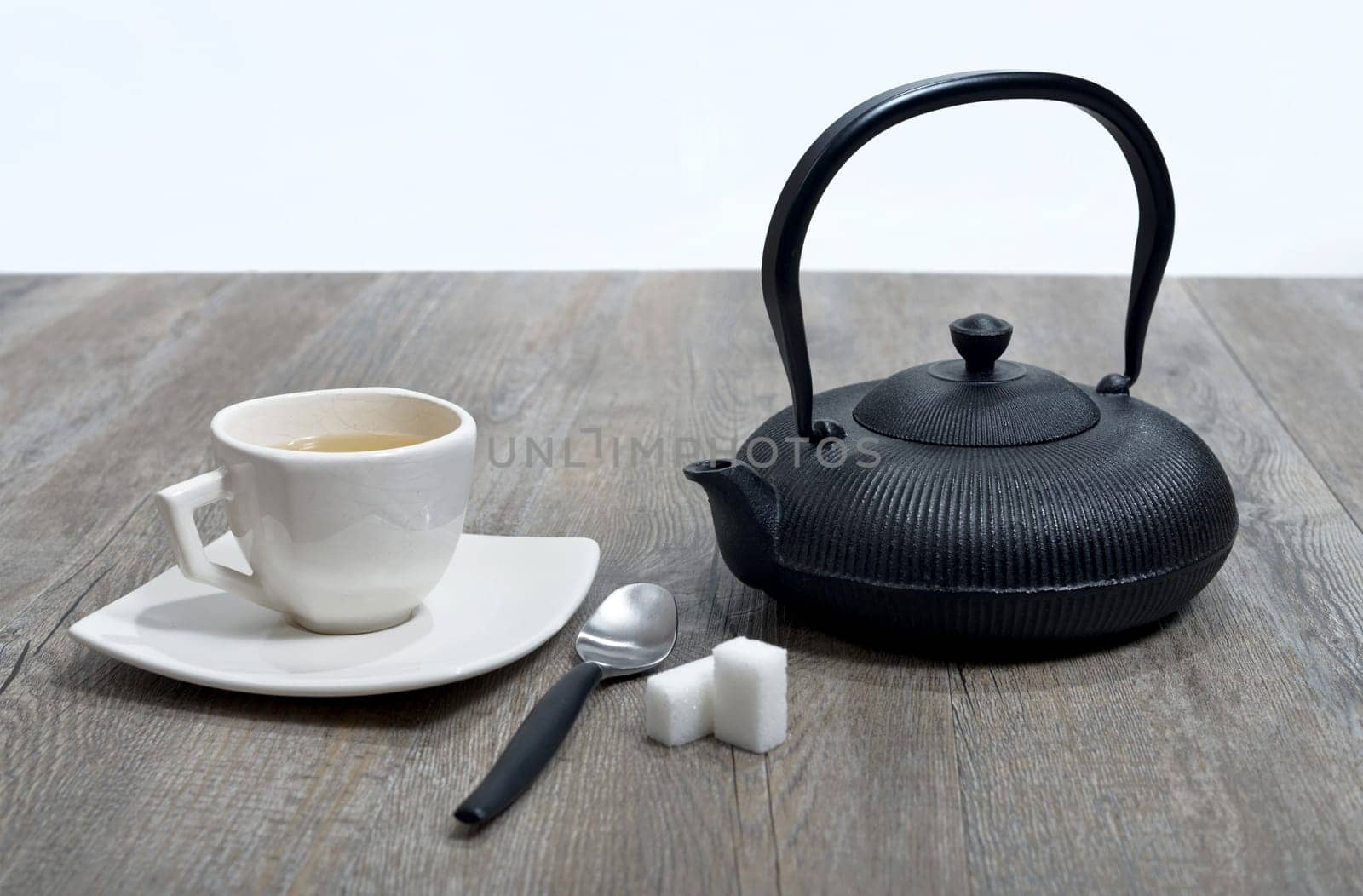 cup of tea with a teapot black.