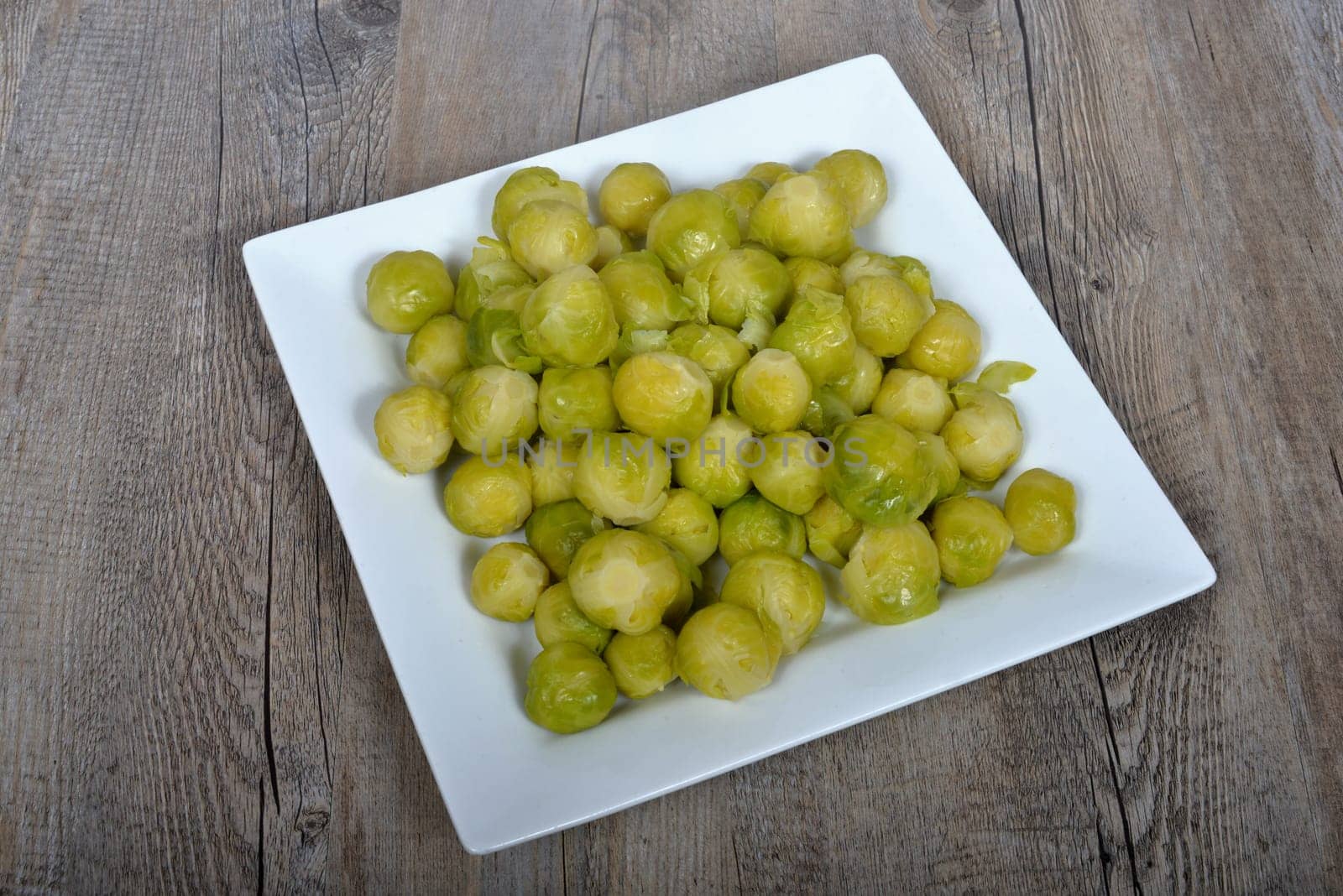 plate of brussels sprouts on the wood table