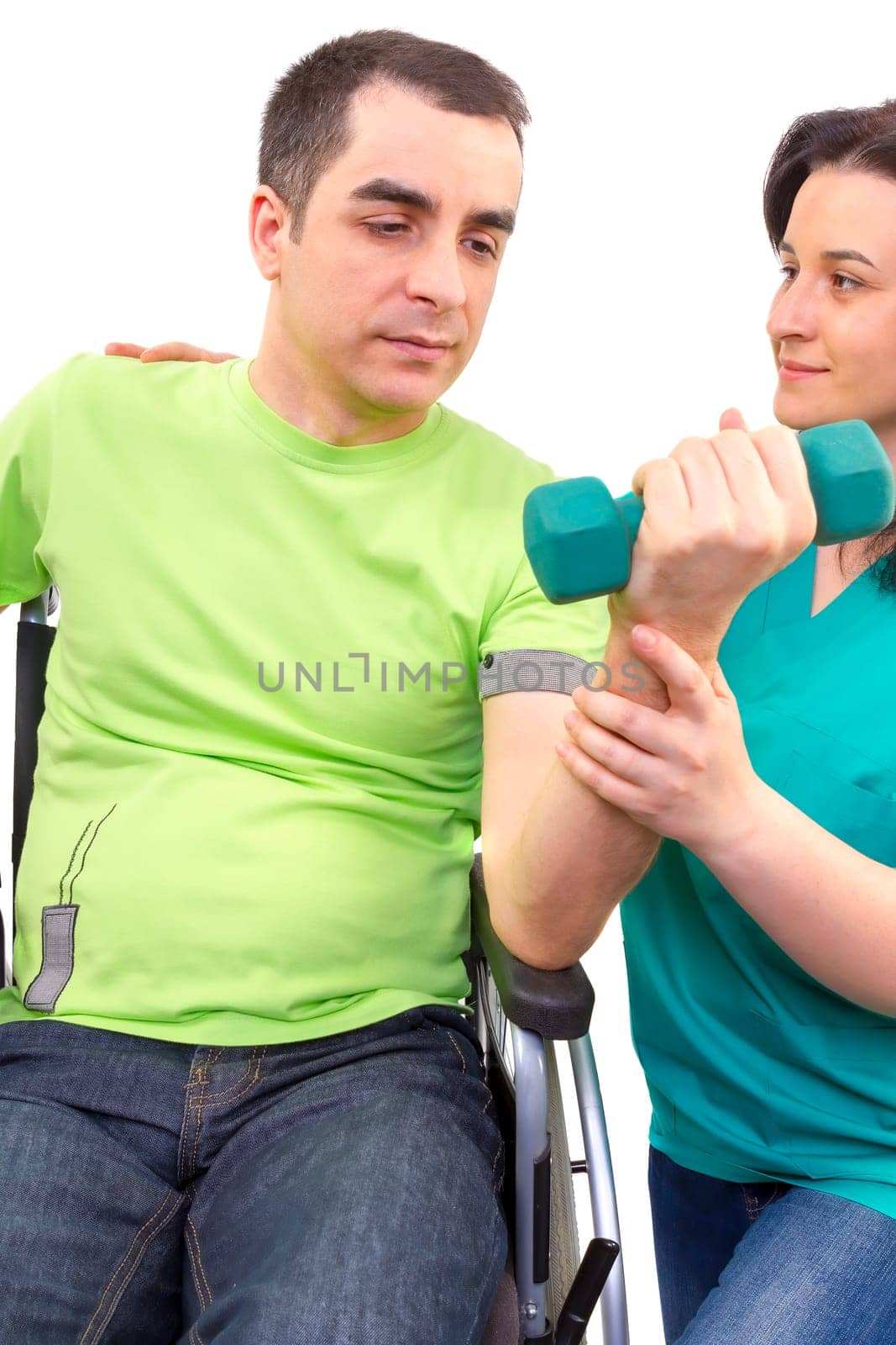 Physical therapist works with patient in lifting hands weights. young adult in wheelchair.