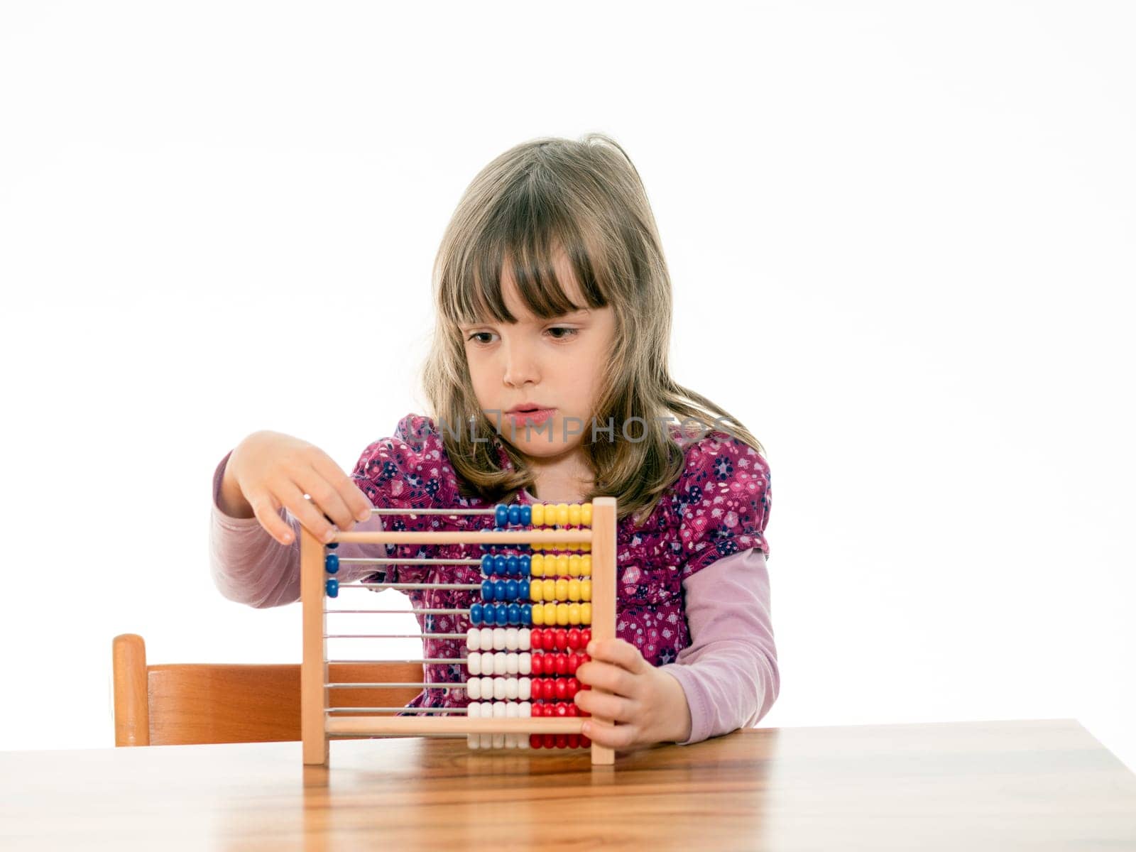 Child reckons with abacus