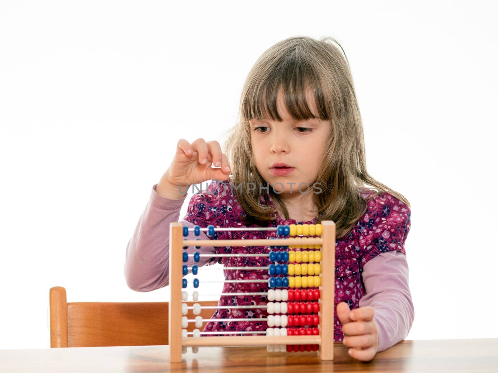 Child reckons with abacus