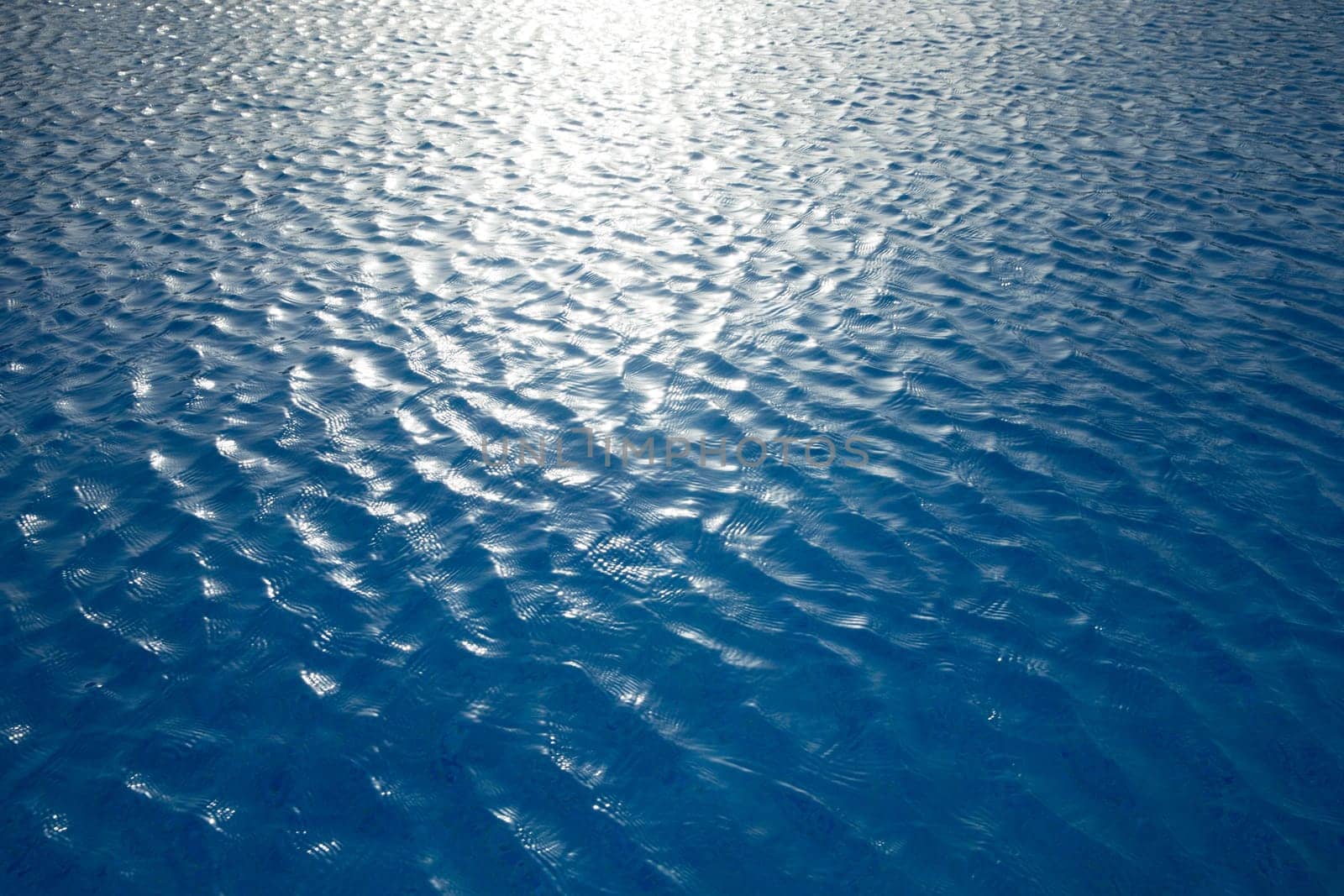 Blue water with sun reflections