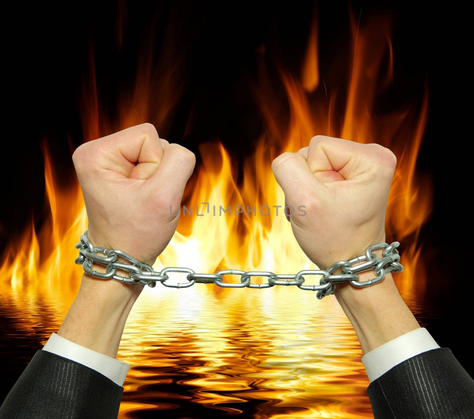 Hands in chains on a fire  background