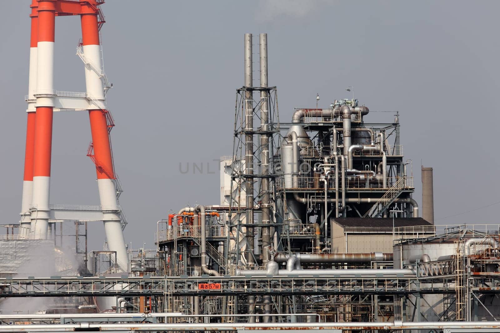 Industrial refinery plant with smokestack