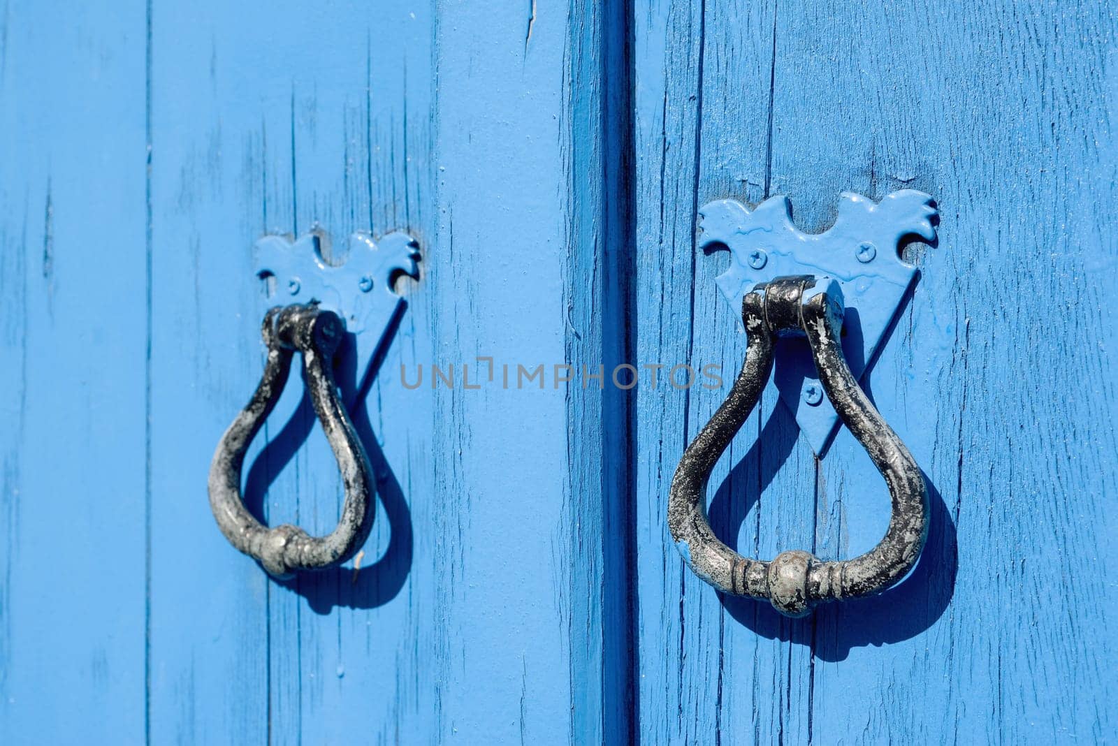 Old blue wooden door with round handles