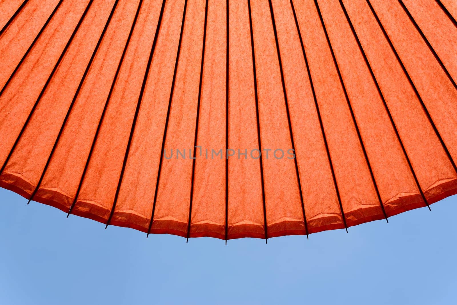 Japanese red umbrella against clear blue sky