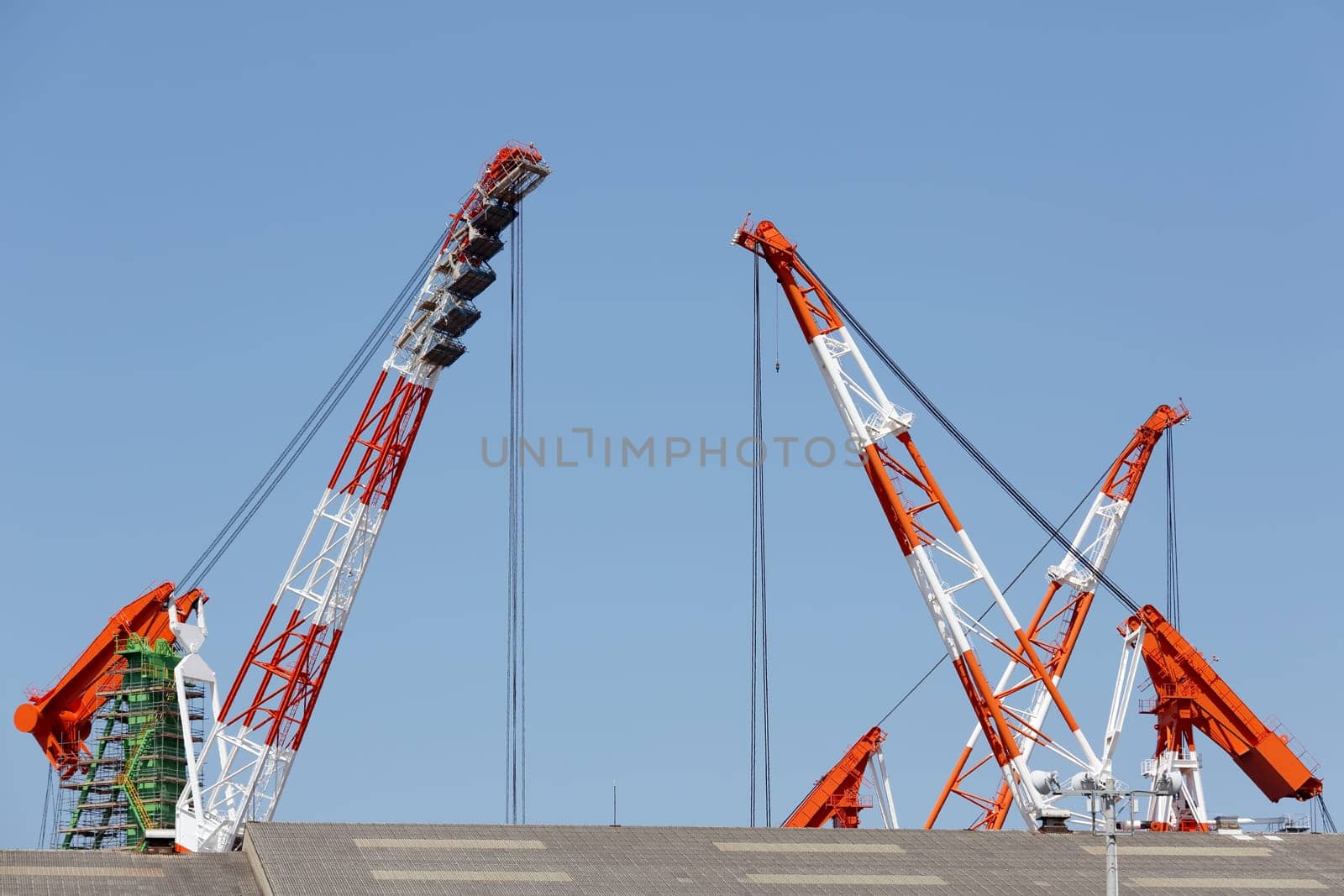 Building crane boom against a clear blue sky