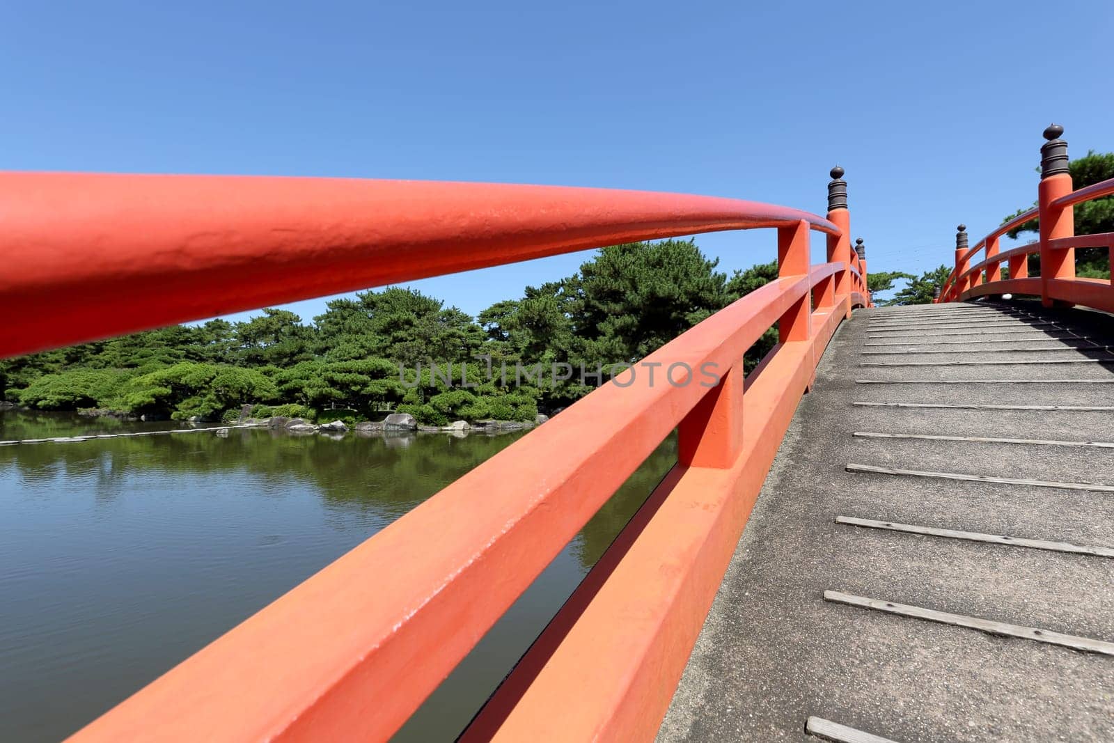 View of red wooden bridge in the Japanese park
