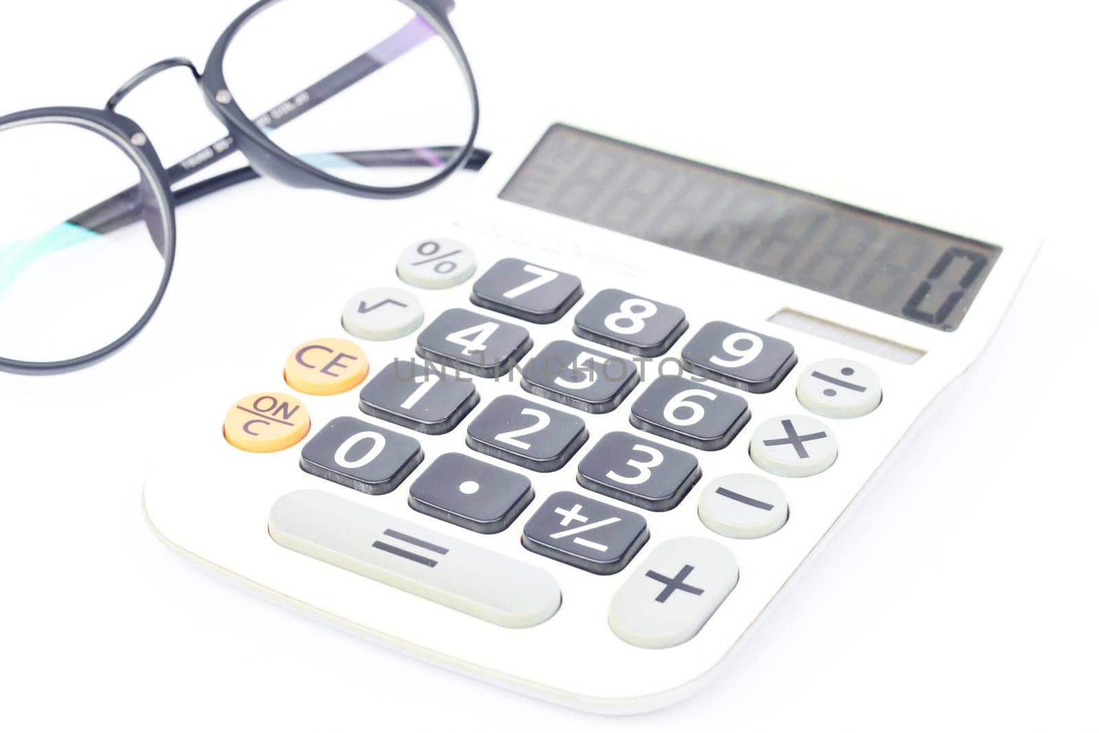 Calculator with eyeglasses isolated on white background, stock photo