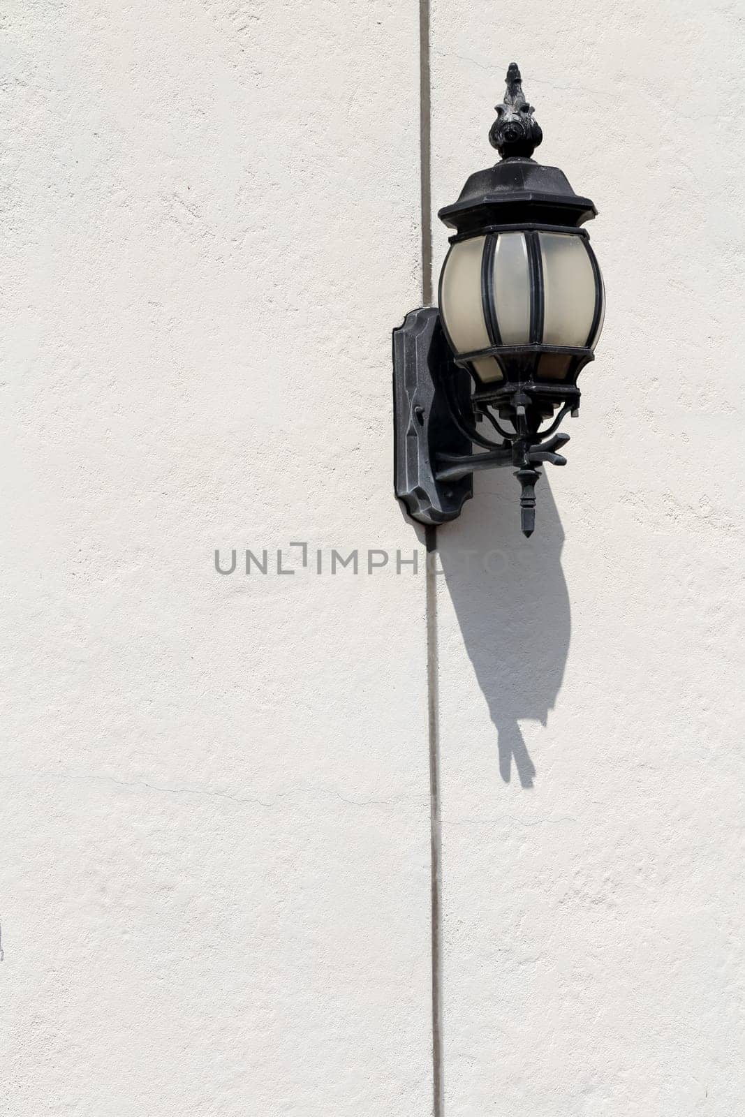 Old lamp lantern on the white wall