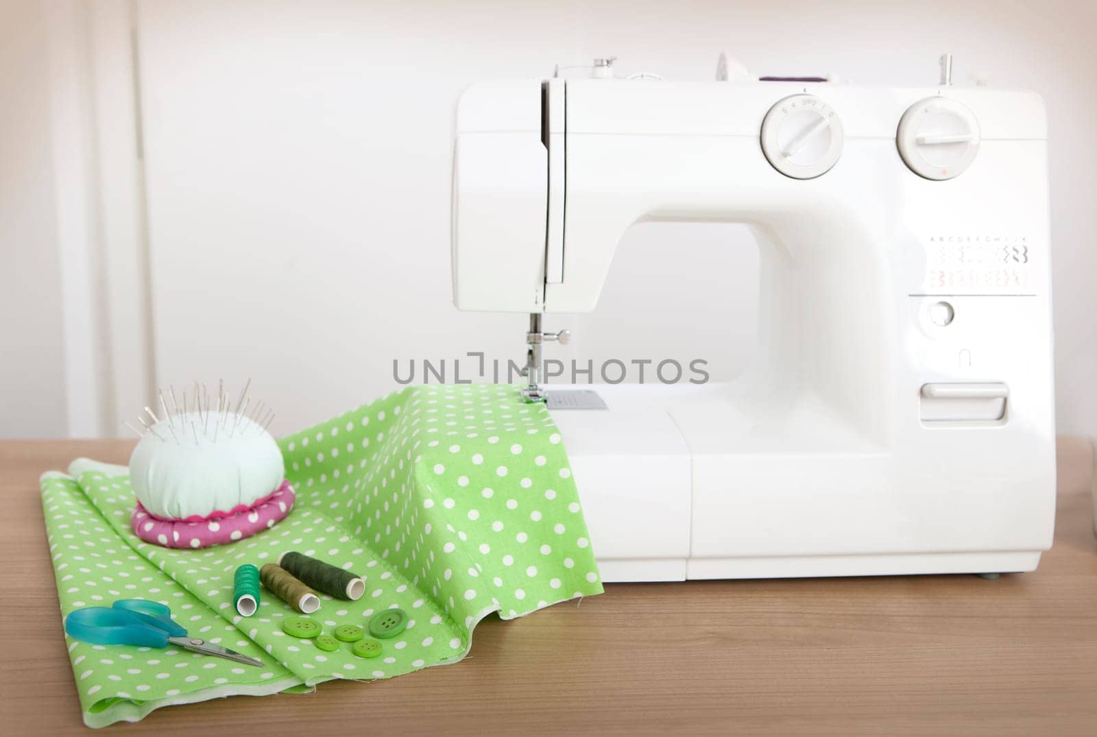 with a sewing machine a green cloth is sewn over