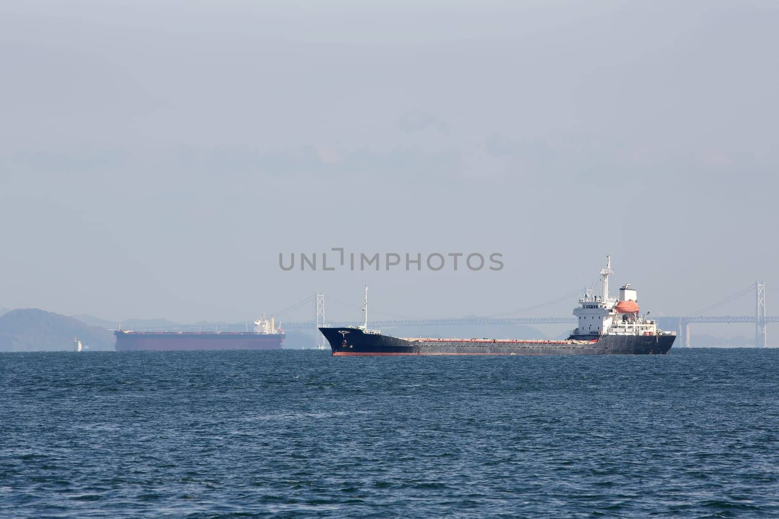 large cargo freighter ship against blue sky