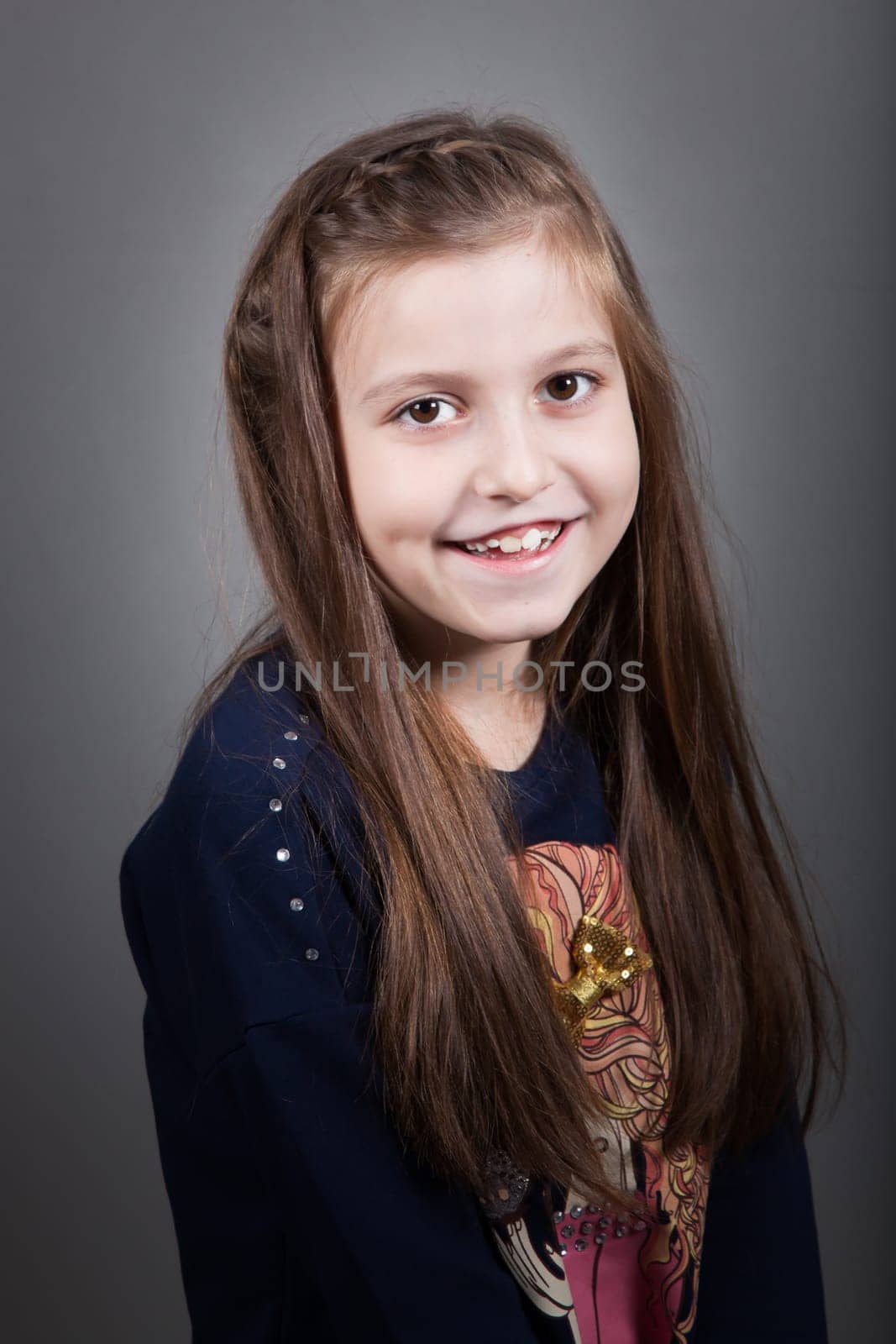 Portrait of a 8 year old girl, nicely dressed, studio shot.