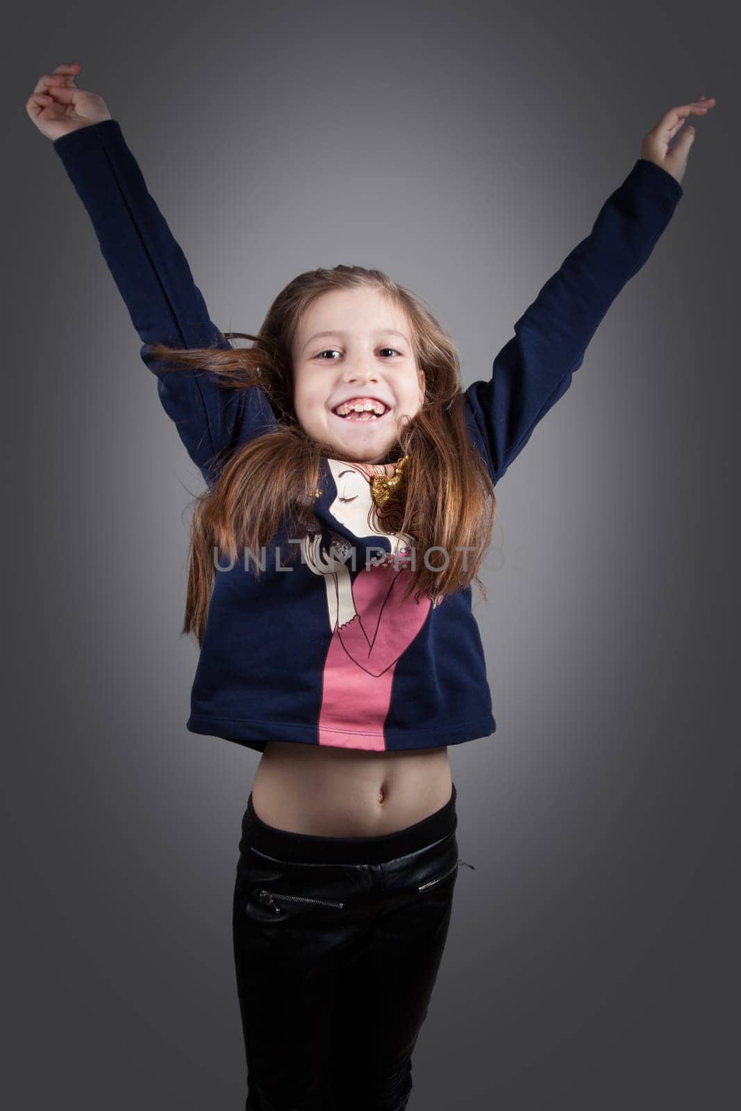 Portrait of a 8 year old girl, nicely dressed, studio shot.