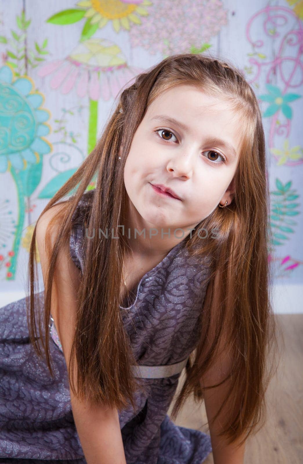 Portrait of a 8 year old girl, nicely dressed, studio shot.